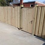 Wooden fence with gate built by Emperor Fence LLC