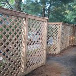 Wooden lattice fence installed by Emperor Fence LLC