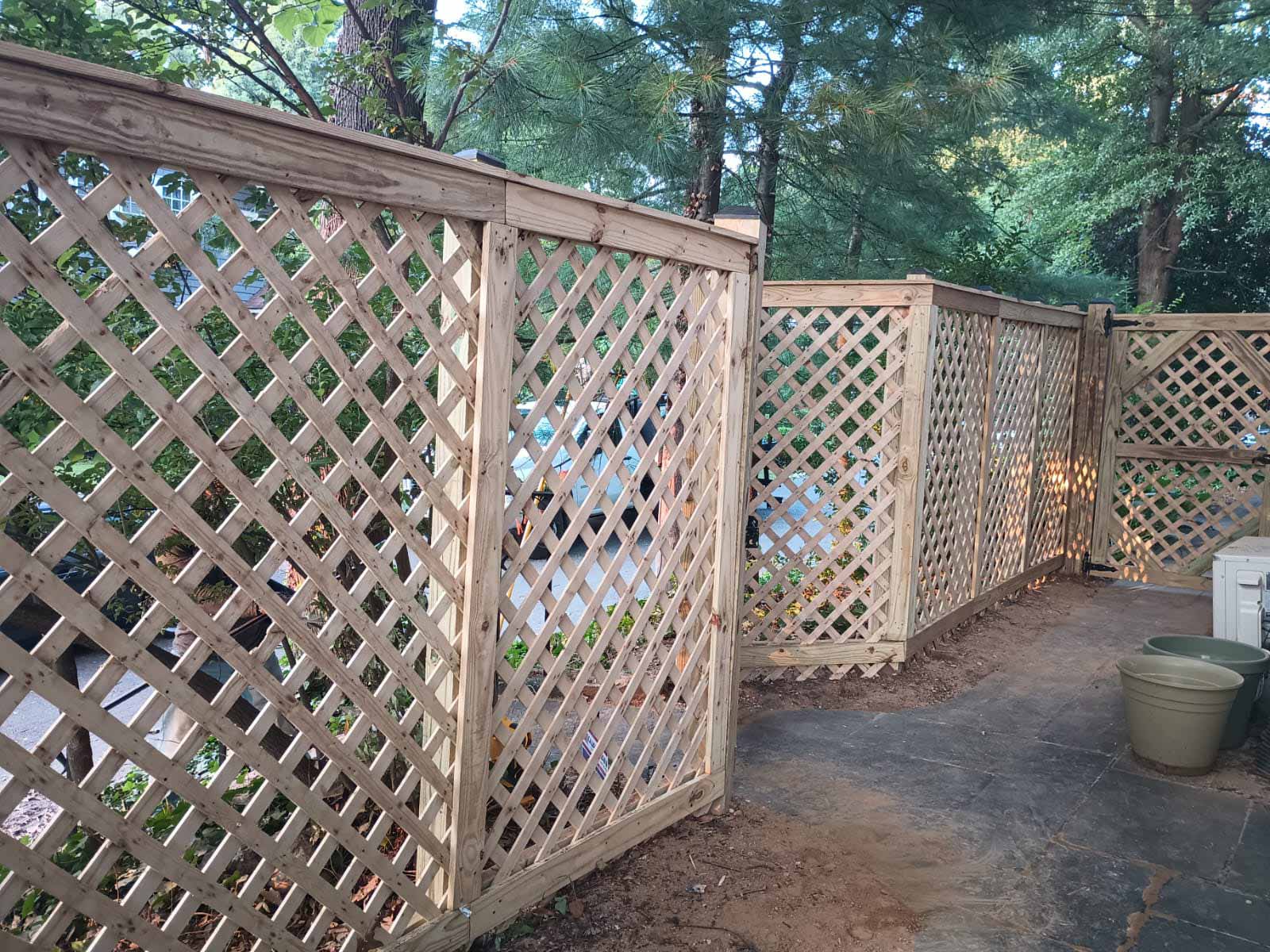Wooden lattice fence installed by Emperor Fence LLC