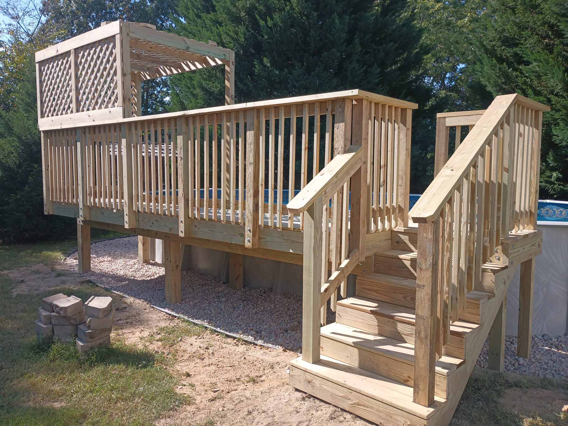 Wooden pool deck installed by Emperor Fence LLC