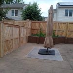 Decorative wooden privacy fence installed by Emperor Fence LLC