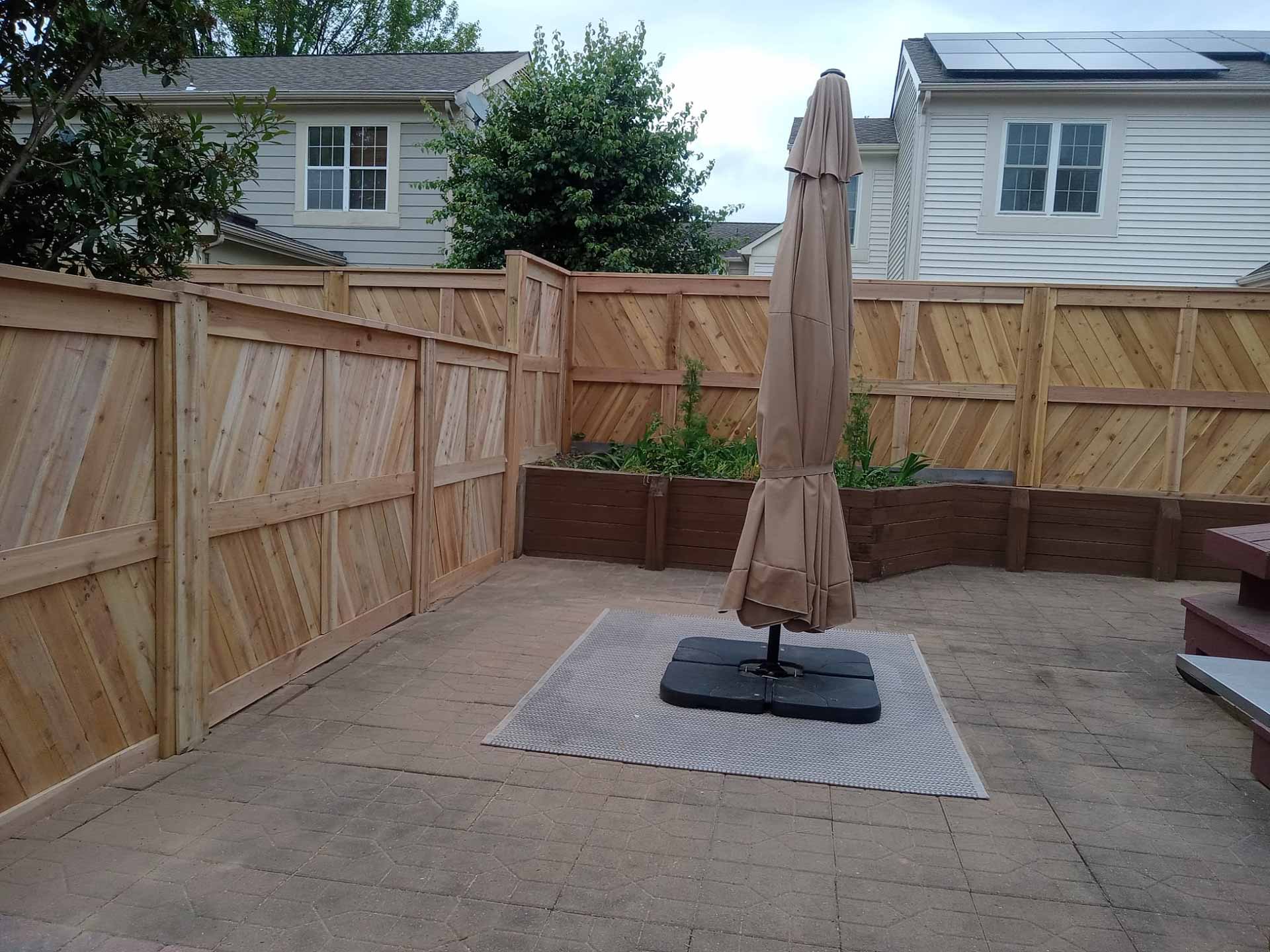 Decorative wooden privacy fence installed by Emperor Fence LLC