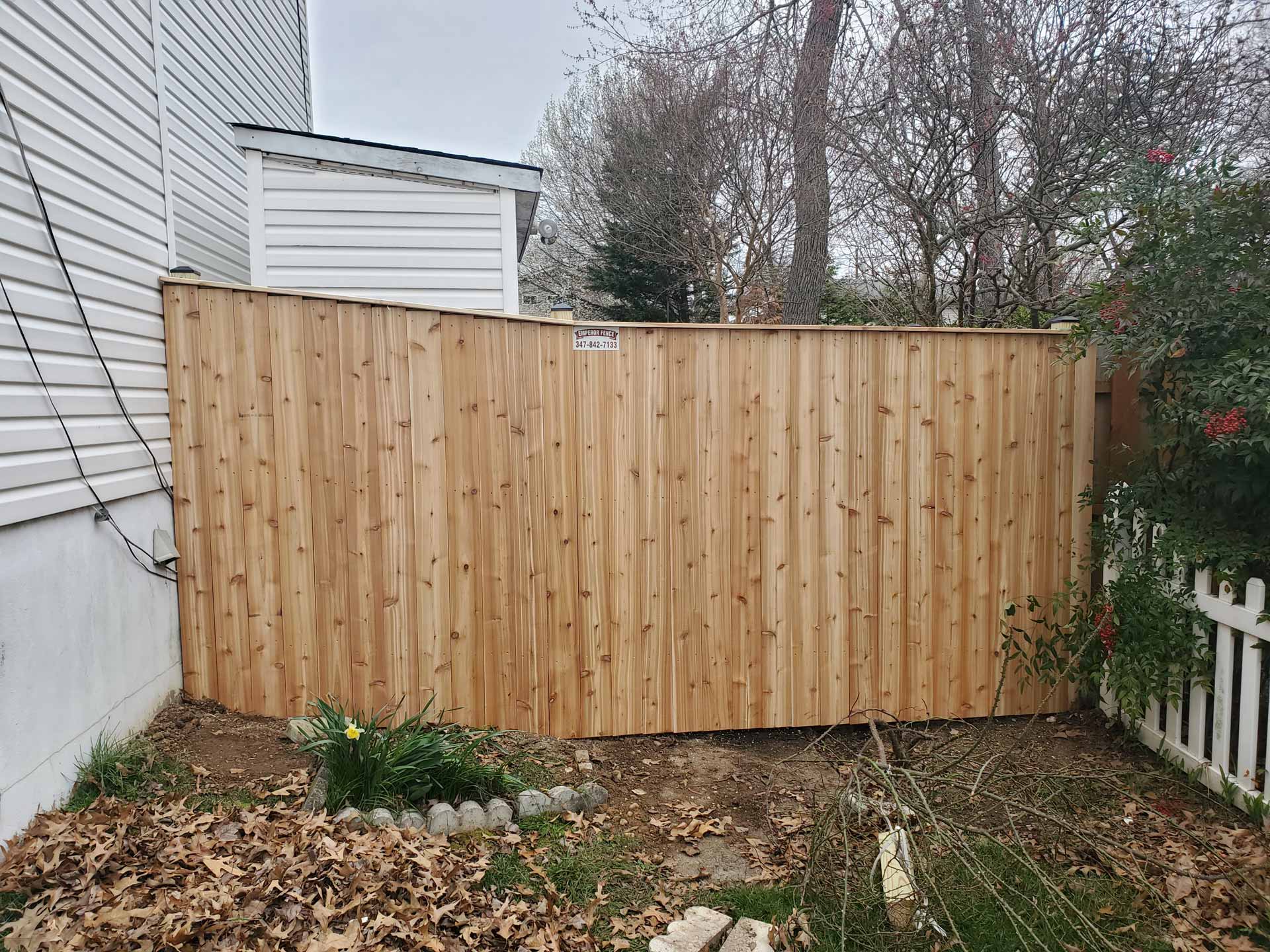 Wooden privacy fence installed by Emperor Fence LLC