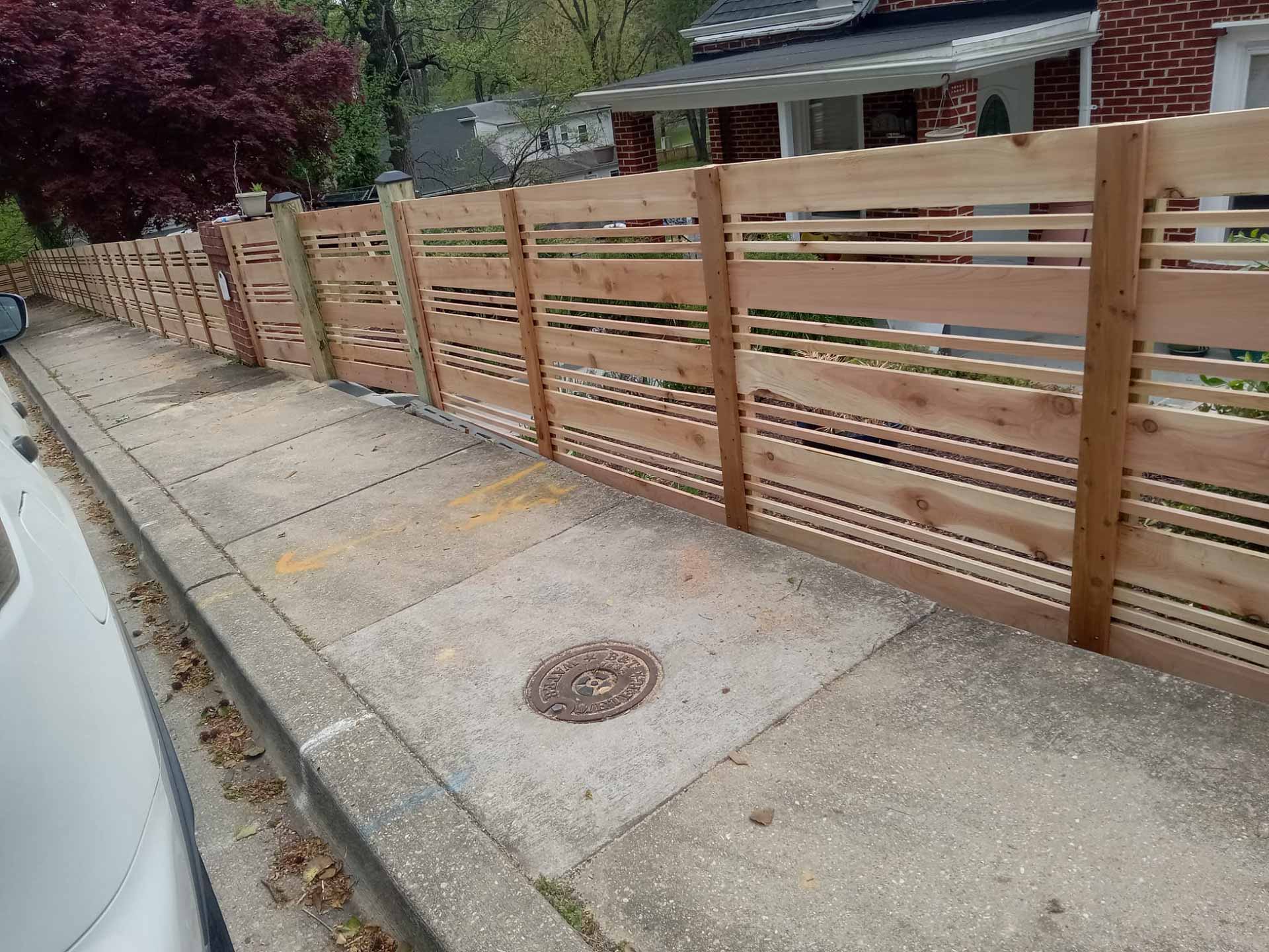 Decorative wooden fence installed by Emperor Fence LLC