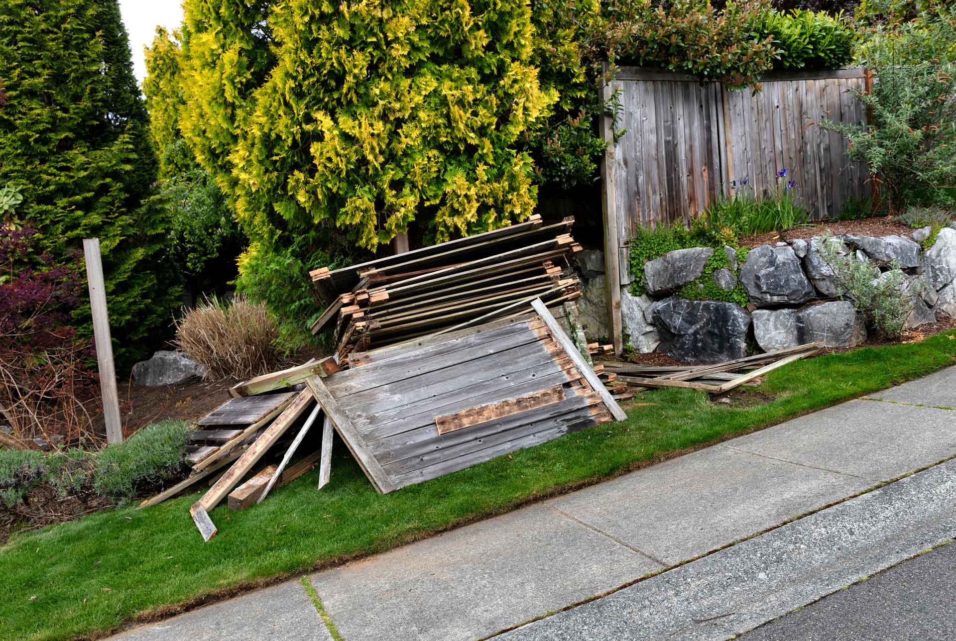 Old wooden fence panels dissembled by the curb