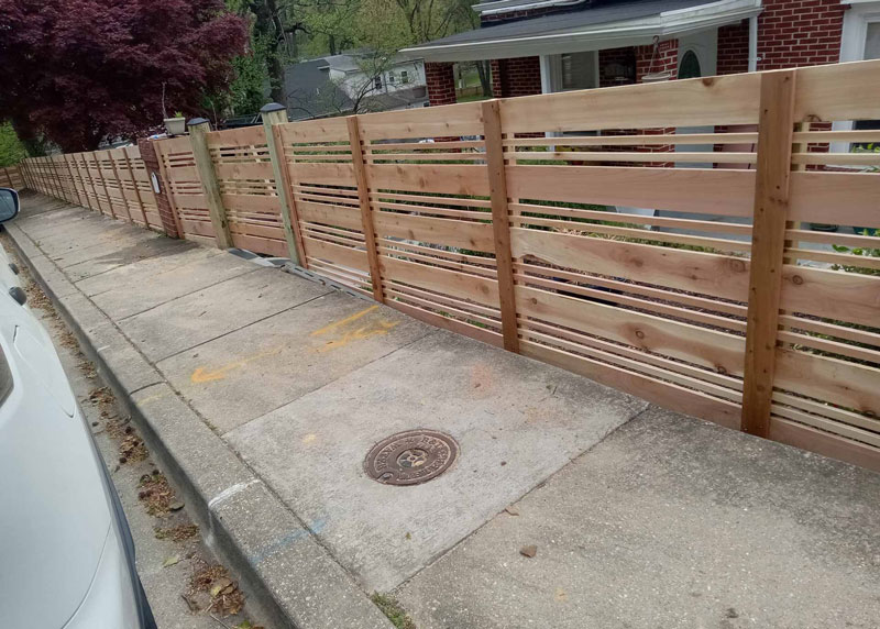 Decorative wooden fence installed by Emperor Fence LLC