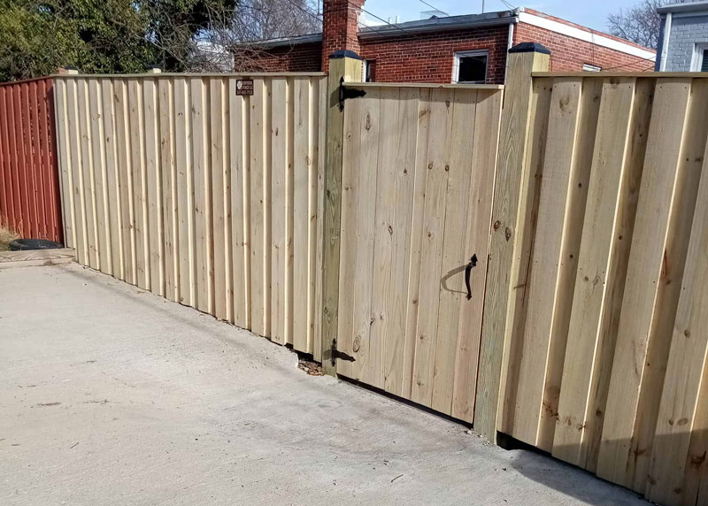 Wooden fence with gate built by Emperor Fence LLC