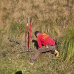 worker in Emperor Fence LLC uniform installing a chain link fence