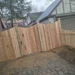 Wooden fence with gate built by Emperor Fence LLC